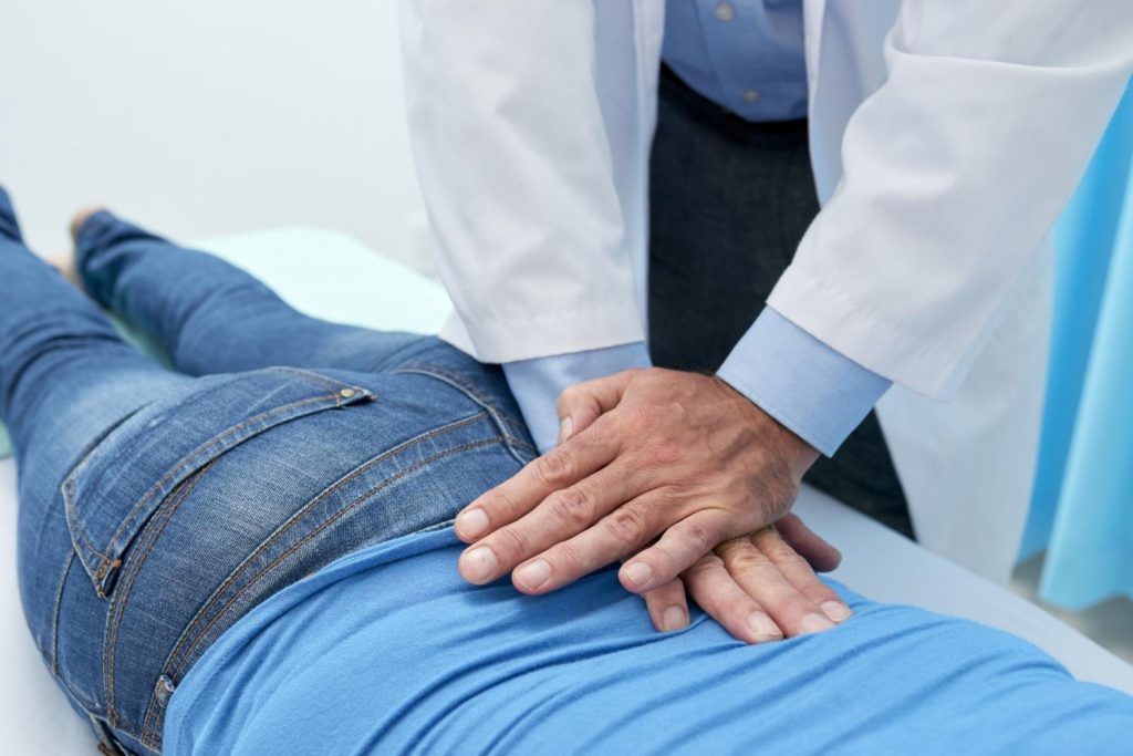 Osteopath using gentle massage techniques on a patient’s back