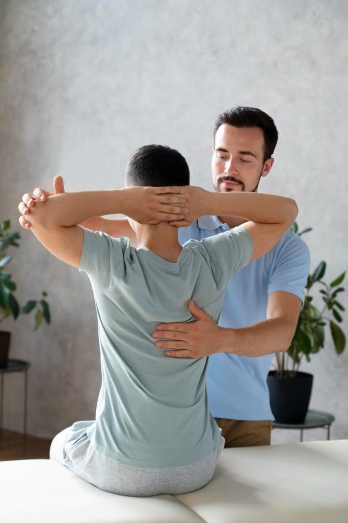 Chiropractor supporting patient during hands-on care
