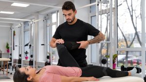 Chiropractor assisting a patient during a hands-on treatment session to support mobility and pain relief