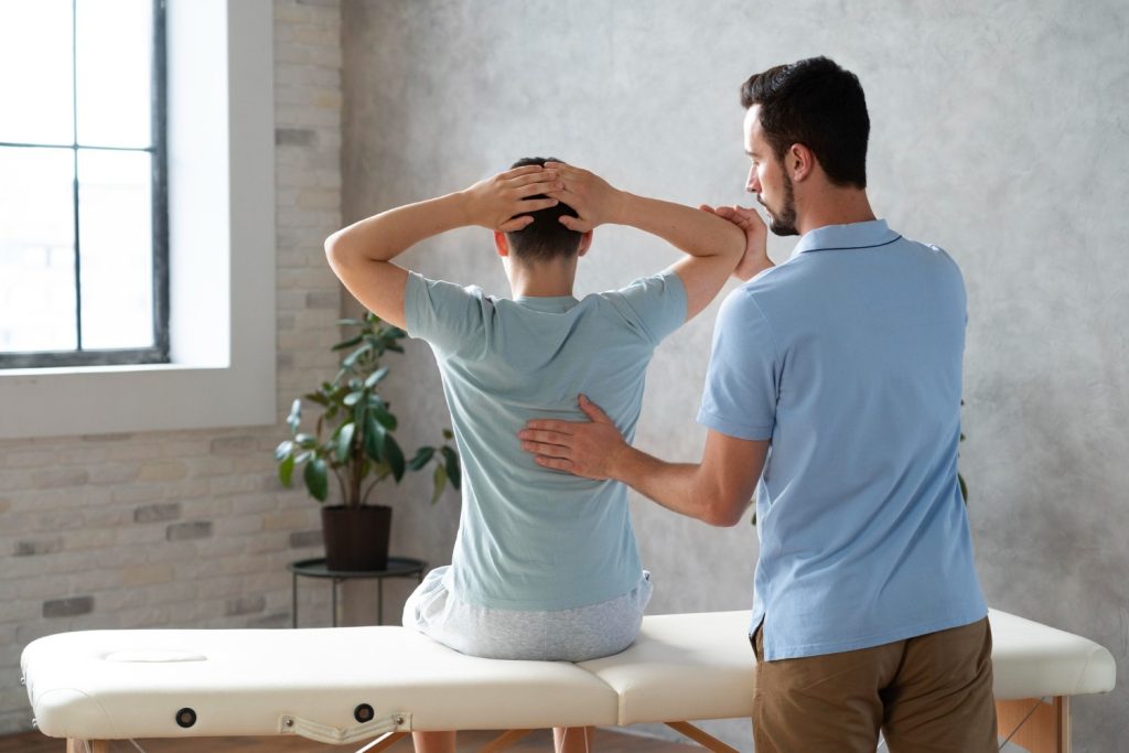 Professional examining the back and performing back adjustment