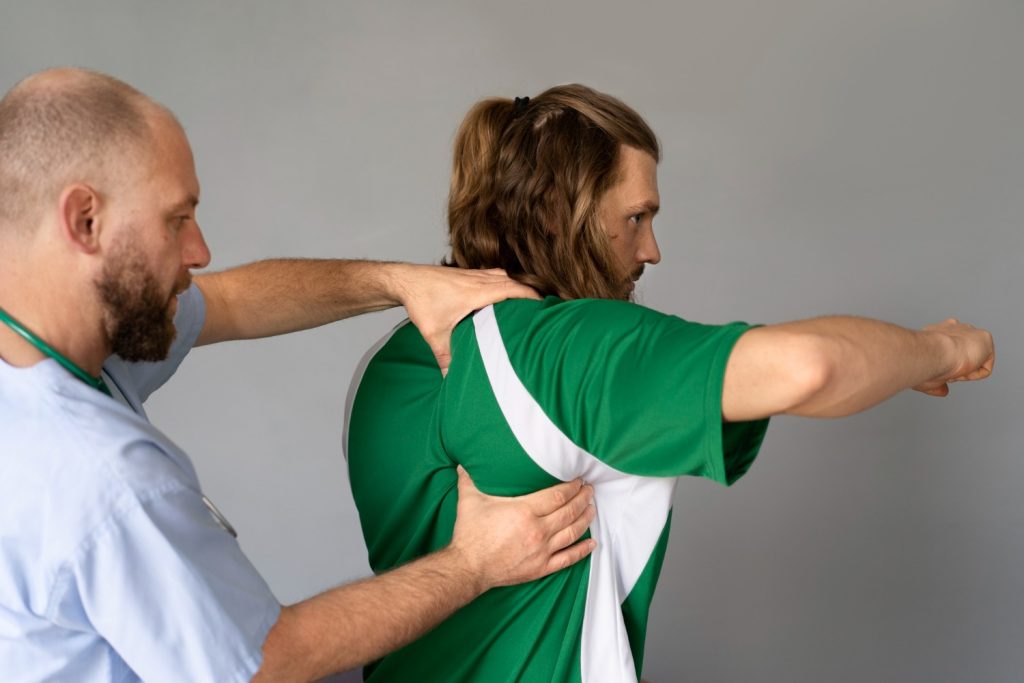Kelowna Chiropractor performing a precise shoulder adjustment to support joint alignment and mobility