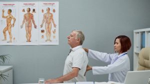 Professional checking senior patient for chiropractic treatment