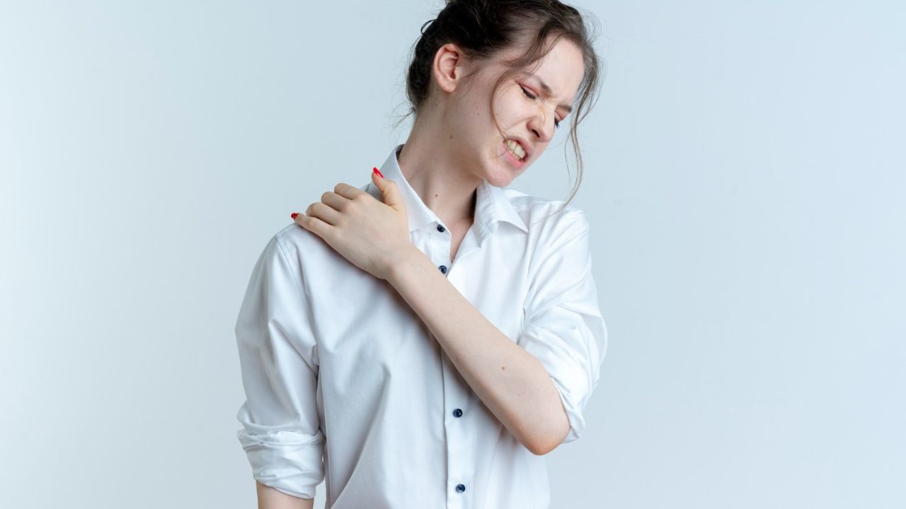 woman feeling uneasy with shoulder pain