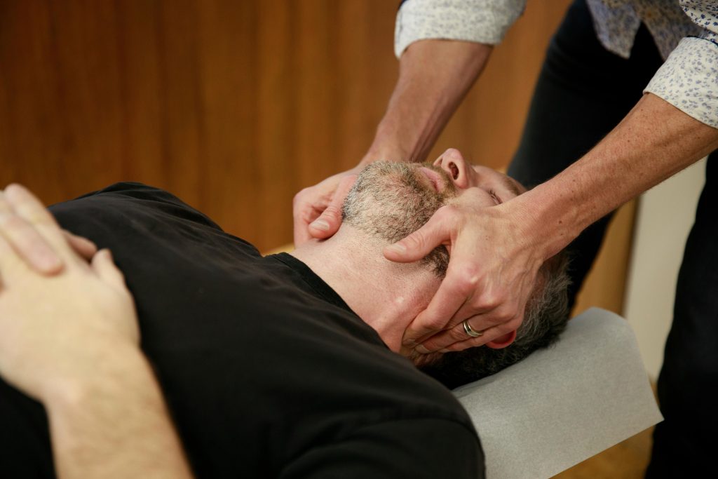 Chiropractor professionally adjusting a patient’s neck during a chiropractic treatment session