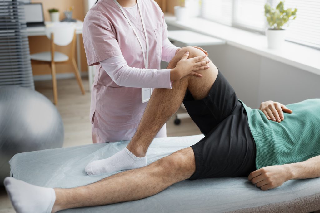 Doctor assisting a patient during a guided rehabilitation session