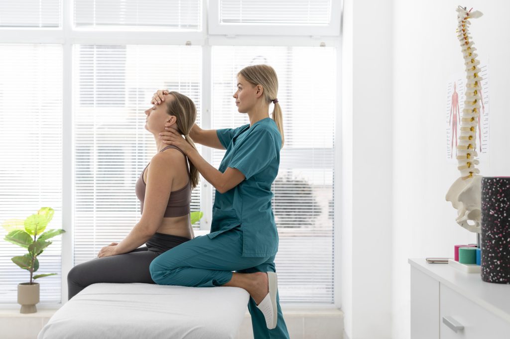 Chiropractor helping a female patient during a chiropractic session at the clinic