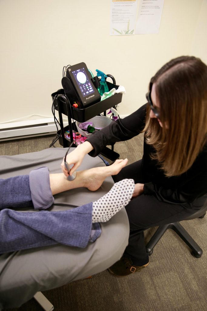 Chiropractor working with patient during physical assessment session