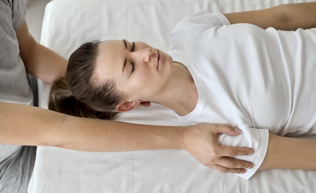 Female patient receiving chiropractic care while lying comfortably on a treatment table.