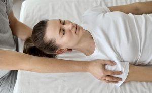 Female patient receiving chiropractic care while lying comfortably on a treatment table.
