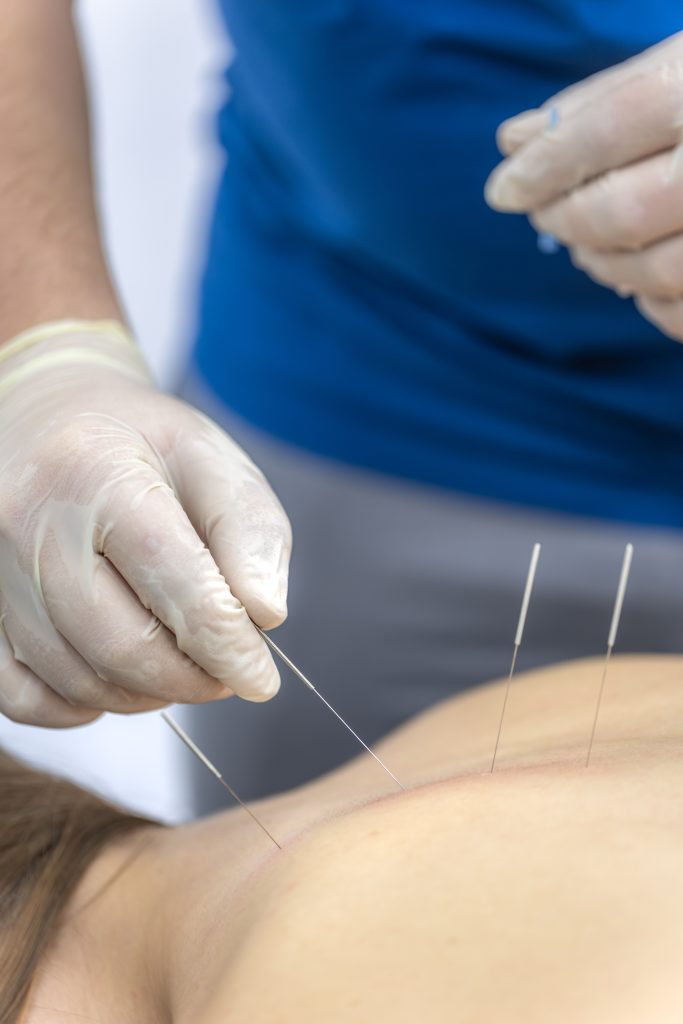 Doctor checks collarbone and shoulder of female patient in rehab. Pain assessment.