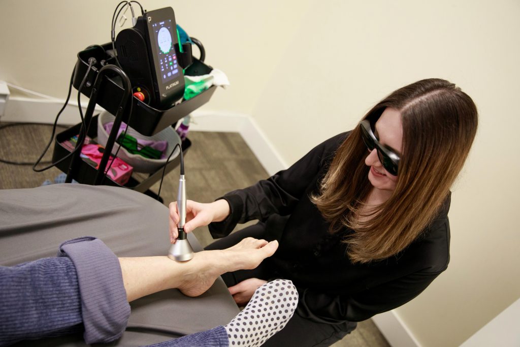 Chiropractor performing gentle therapy on a patient during a treatment session.