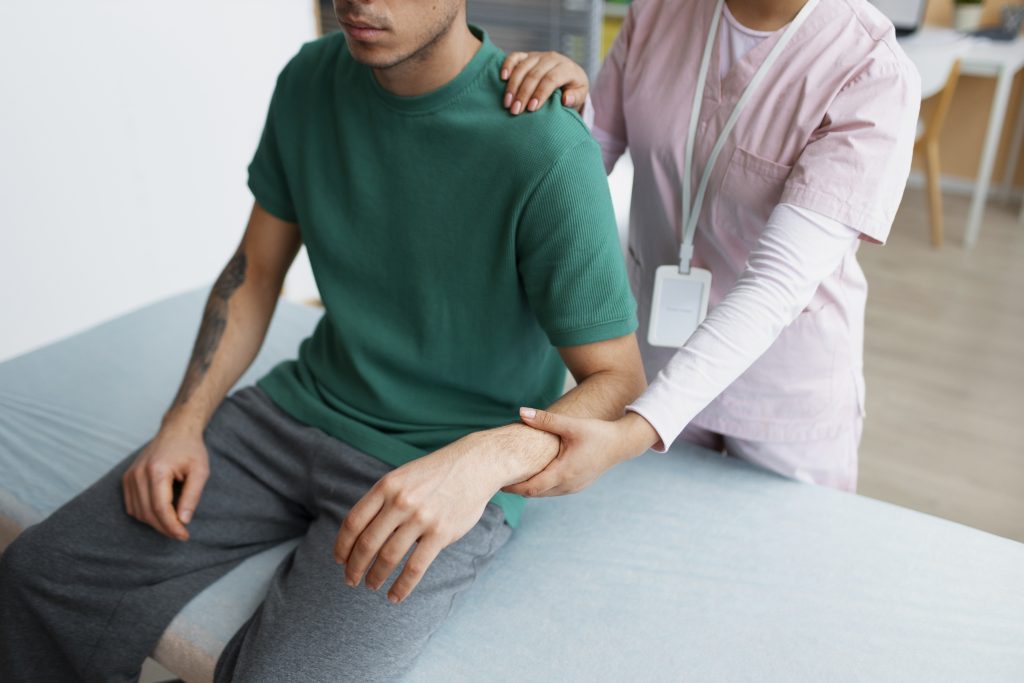 Patient getting his neck and arm treated in chiropractic care