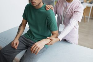 Patient getting his neck and arm treated in chiropractic care